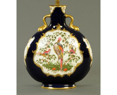 A Worcester style moon flask, decorated with birds and converted to a lamp.  Height of flask 30 cm, diameter +/- 25 cm. 