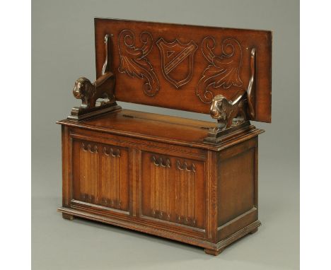 An oak monks bench, bearing plaque "L. Marrus Limited, London".  Width 106 cm. 