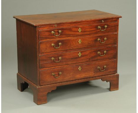 A George III mahogany chest of drawers, with slide above four long graduated drawers with brass drop handles and lock escutch