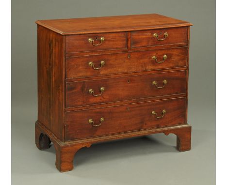 A George III mahogany crossbanded chest of drawers, with two short and three long drawers with brass drop handles and cockbea