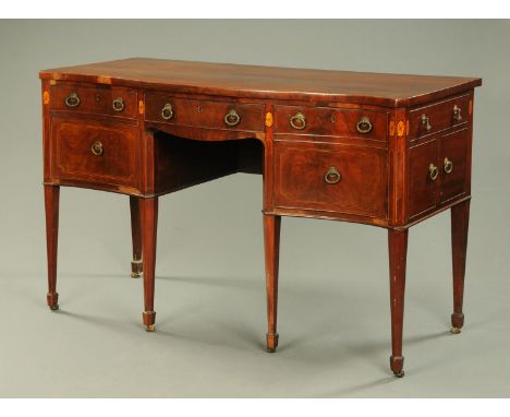 A George III mahogany serpentine fronted sideboard, fitted with a series of drawers and raised on tapered legs of square sect