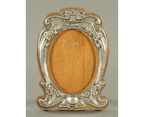 A silver Art Nouveau photograph frame, J, Aitken & Son, Birmingham 1904, with embossed floral decoration and verse "Friendshi