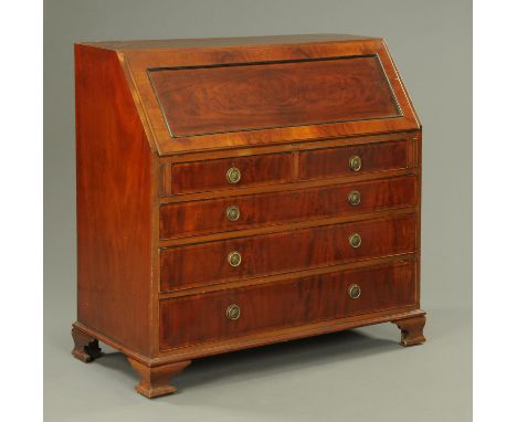 An Edwardian mahogany bureau, with slope front to well fitted interior and with two short and three long graduated drawers an