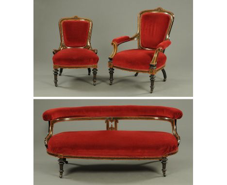A Victorian Aesthetic period three piece suite, circa 1880, with amboyna and ebonised showframe with incised decoration and r