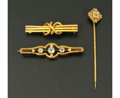 A 9 ct gold bar brooch, set with seed pearls and pale blue stones, a 15 ct gold bar brooch and a cased stick pin, 