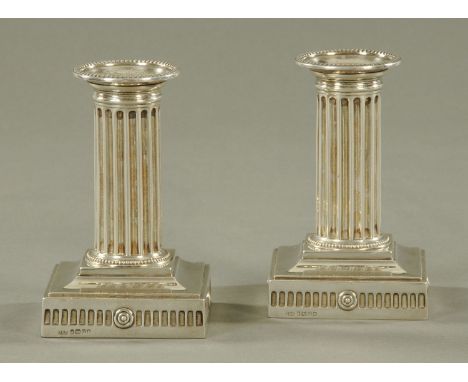 A pair of dwarf silver candlesticks, Hawksworth, Eyre & Co. (James Kebberling, Bembridge), Sheffield 1883, with removable bea