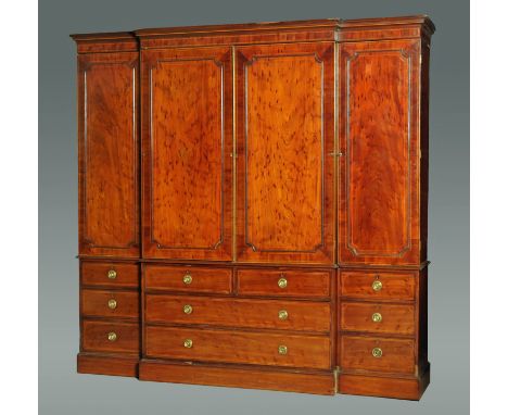 A 19th century mahogany breakfront large wardrobe, with detachable moulded cornice above a centre pair of panelled cupboard d