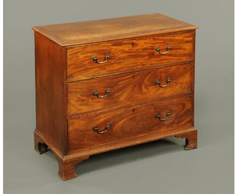 A George III mahogany chest of drawers, with crossbanded moulded edge above three long graduated drawers with brass swans nec