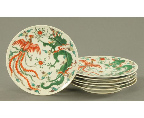Six Chinese Famille Verte plates, 20th century, decorated with dragons and Feng amongst clouds and with two flaming pearls, s