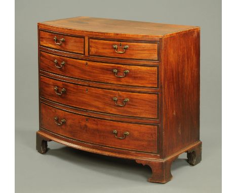 A George III mahogany and rosewood crossbanded bowfronted chest of drawers, with two short and three long drawers with brass 