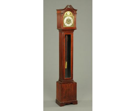 A mahogany granddaughter clock, with three-train striking movement, bevelled glass door and raised on bracket feet.  Height 1