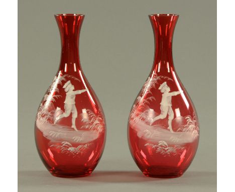 A pair of Mary Gregory style cranberry glass vases, late 19th century, with white opaque enamel decoration, young boy in wood