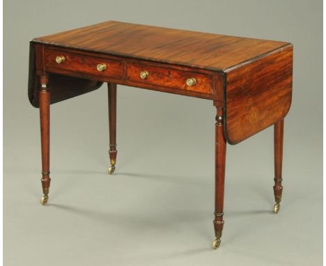 A George III mahogany sofa table, fitted with two frieze drawers with brass knob handles and raised on turned tapered legs.  