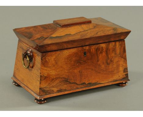 A rosewood sarcophagus shape tea caddy, 19th century, the interior with two removable caddies and vacant centre section, rais