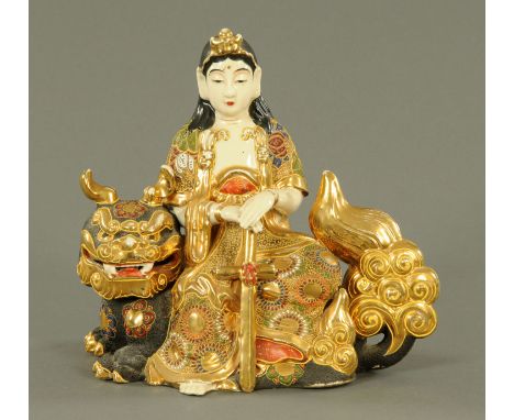 A Satsuma figure of Avalokitesvara, Taisho, seated on a Shi-Shi lion in Moriagi style enamel, four character mark to undersid