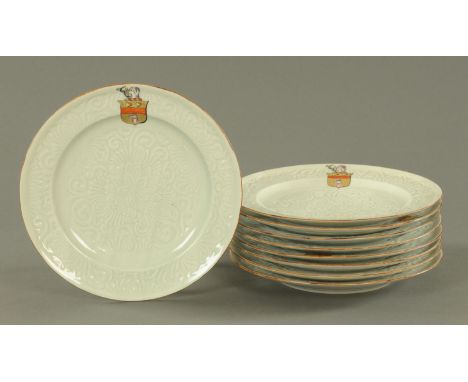 A set of nine armorial plates, late 20th century, in the Chinese Celadon style, with relief moulded flower and scroll decorat