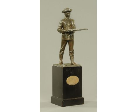 A patinated spelter figure, Great War soldier, early 20th century, modelled with his rifle held at hip height, indecipherable