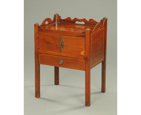 A George III mahogany bedside cabinet, converted from a commode, with carrying handle to either side and raised on legs of sq