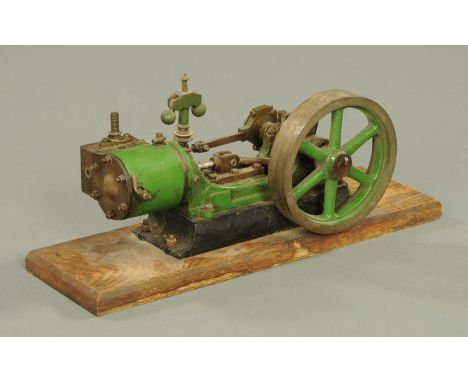 A stationery engine, green livery, mounted on an oak plinth.  Length of plinth 39 cm, width 12 cm.