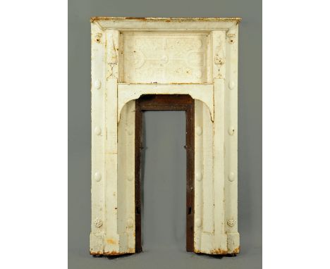 An Arts & Crafts cast iron fire surround, late 19th century, with recessed panel with compartmentalised floral decoration, wi