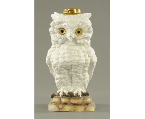 A Continental porcelain oil lamp base, circa 1880, modelled as a long eared owl gripping a twig on rockwork base and with ins