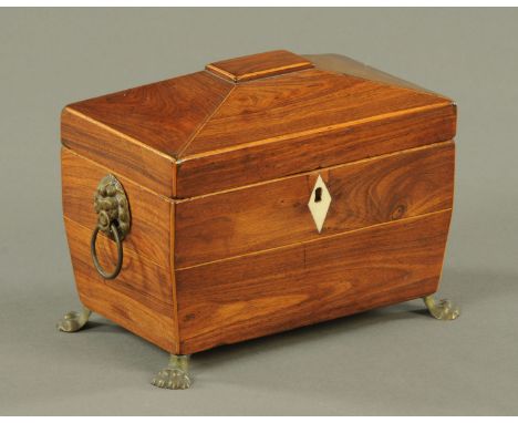 A rosewood sarcophagus shaped tea caddy, circa 1820, the interior with two compartments, with turned ivory knops, ivory escut