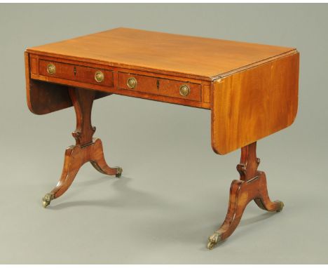 A 19th century mahogany sofa table, each flap with rounded corners, fitted to the frieze with two drawers and raised on silho