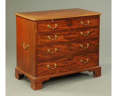 A George III mahogany chest of drawers, with brushing slide, the rectangular top with applied moulded edge above the slide an