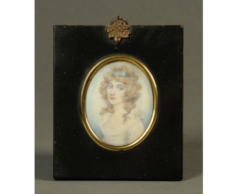 A 19th century portrait miniature on ivory, oval, female figure with blue hair ribbon.  68 mm x 55 mm, ebonised frame, acorn 