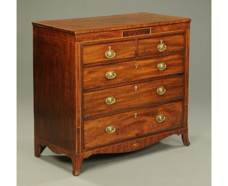 A George III mahogany chest of drawers, with crossbanded edge, shallow frieze, two short and three long drawers with brass dr
