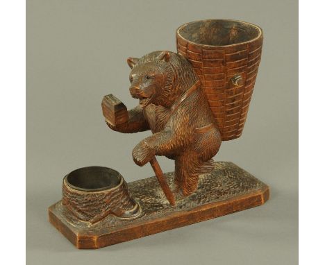 A Black Forest carved spill holder and Vesta, late 19th century, carved as an upright bear with large barrel on his back and 