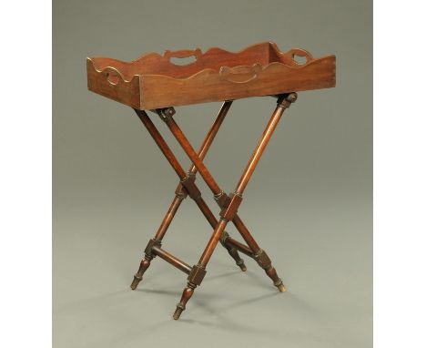 A 19th century mahogany butlers tray, raised on a turned stand.  Width 80 cm. 