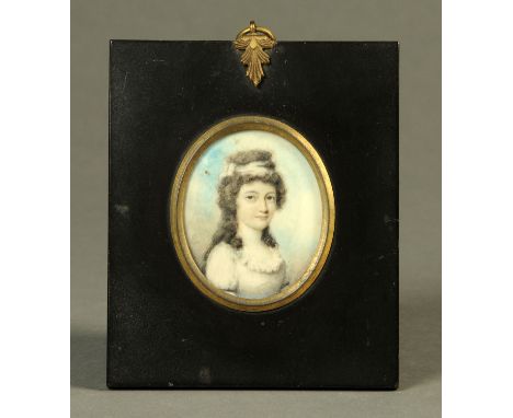 A 19th century portrait miniature on ivory, oval, lady with bow in hair.  60 mm x 50 mm, black painted frame and brass hanger