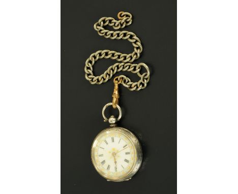 A silver cased foliate engraved fob watch, with ceramic dial and Albert chain.  Diameter 38 mm. 
