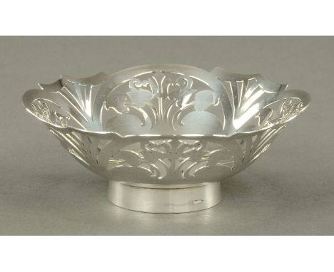 A silver bonbon bowl, with pierced border and raised on a plain ring foot, Sheffield 1991, diameter 12.4 cm, 131 grams, and a