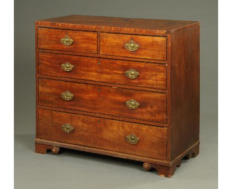 An early 19th century mahogany chest of drawers, with two short and three long drawers with brass drop handles with embossed 