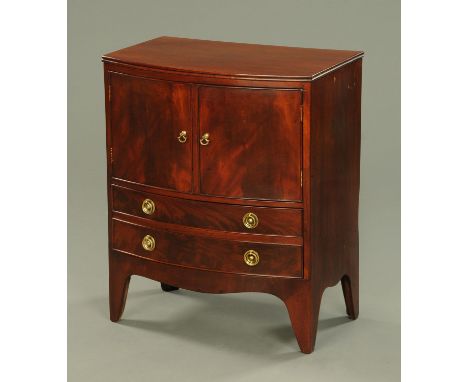 A Georgian mahogany bedside cabinet, converted from a bowfronted commode, with cupboard and drawers and raised on bracket fee