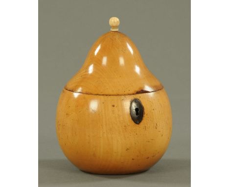 A fruitwood tea caddy, in the form of a pear with turned ivory finial and iron oval escutcheon, zinc lined interior.  Height 