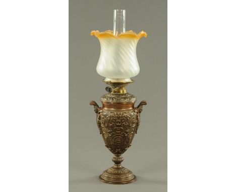 A Wright & Butler cast iron oil lamp, late 19th century, of vase form with leaf moulded stylised foliate decoration and scrol