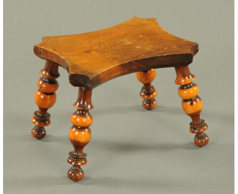 A yew wood lacemakers lamp stool, 19th century, the shaped seat on turned splayed legs.  Width 16.8 cm, height 13 cm. 