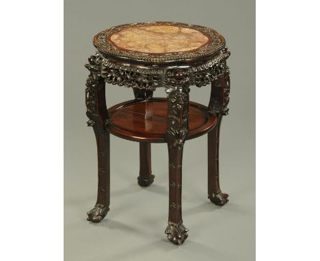A 19th century Chinese hardwood rouge marble topped jardiniere stand, large form, with carved pierced frieze, carved legs and
