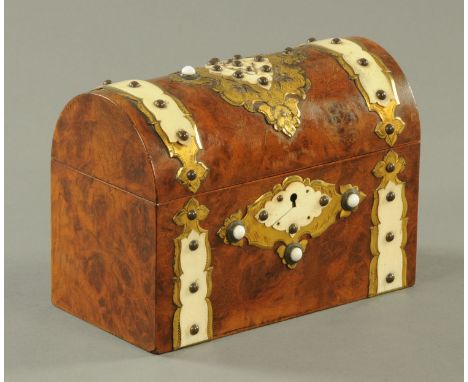A Victorian walnut dome topped tea caddy, brass and faux ivorine mounted.  Length 22 cm (see illustration). 