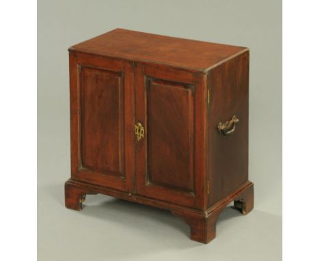 Georgian mahogany table top filing cabinet, early 19th century, the figured top above two panelled cupboard doors, the interi