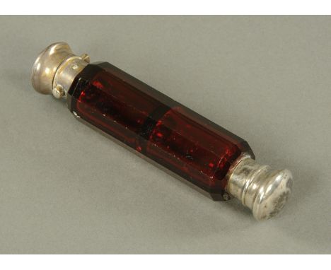 A ruby glass double ended scent bottle, 19th century, the faceted body with either screw or hinged opposing ends.  12.8 cm. 