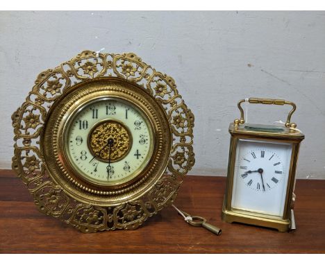 A French brass cased strut clock circa 1905 with cream enamelled Arabic dial, with key, along with a French brass cased five-