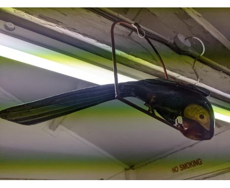A vintage painted paper mâché parrot perched on a painted iron hanging arch, Location: 
