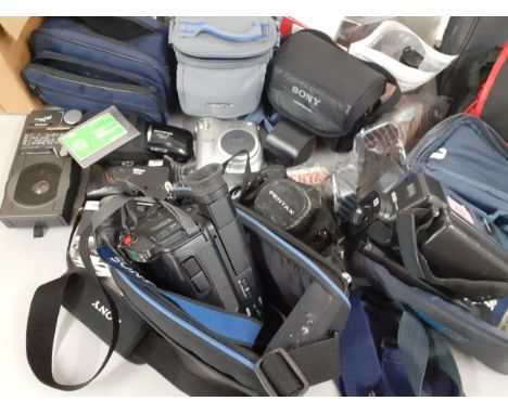 A quantity of vintage cameras, lenses, empty camera bags and photographic accessories to include an Olympus Trip 35, a Nikon 