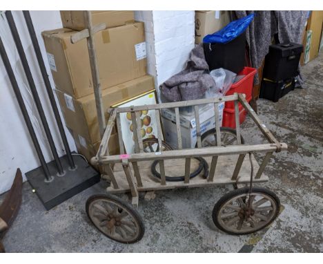 A vintage wooden cart 60cm high x 90cm long (excluding pulling bar) Location: 