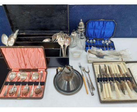 Mixed boxed flatware, teaspoons, a box of miscellaneous cutlery, glass and silver plated sugar sifters and an oil lamp Locati