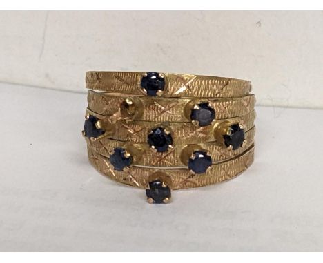An 18ct gold ring having eight sapphires (one missing) stamped 18k, 3.6gLocation: 